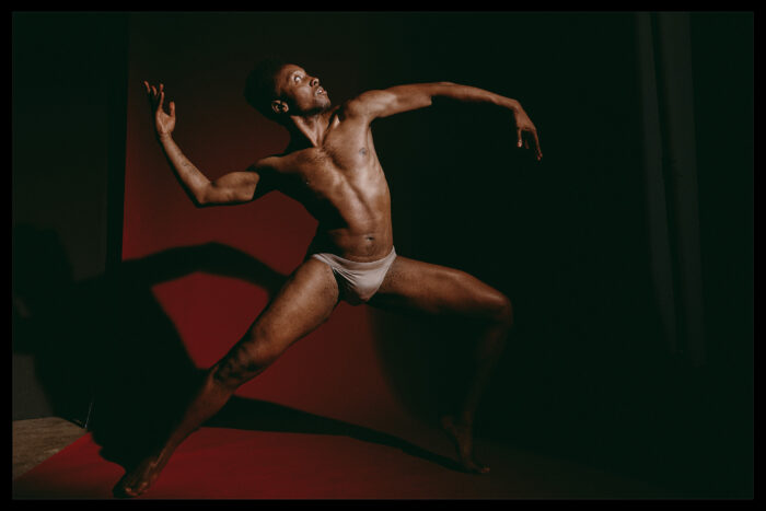 Dancer in Brooklyn studio against red background