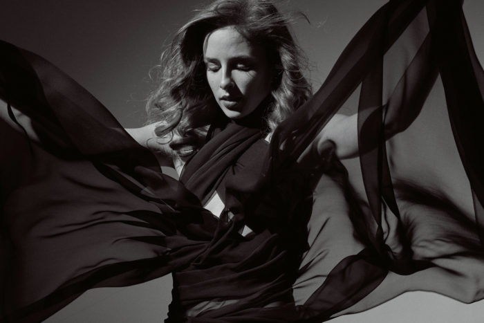 Portrait of dancer with fabric in Brooklyn studio.
