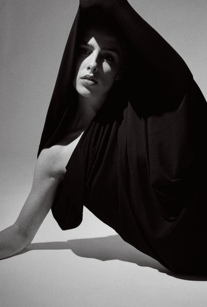 Portrait of dancer in studio, constrained fabric