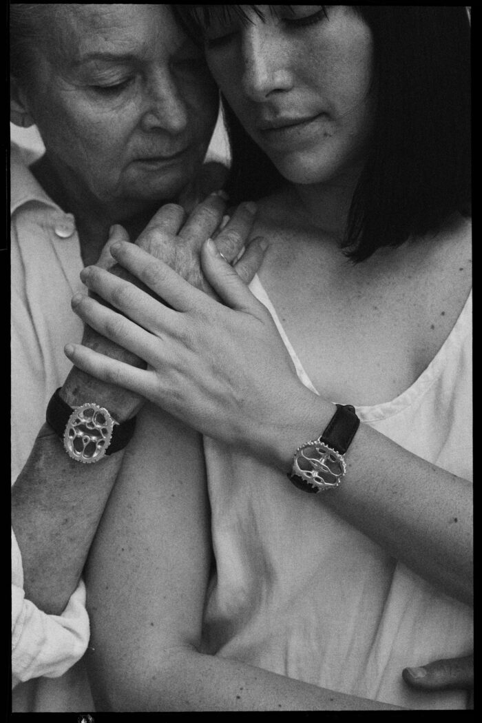 Women embracing, detail of hands, collaboration with The All Watch.