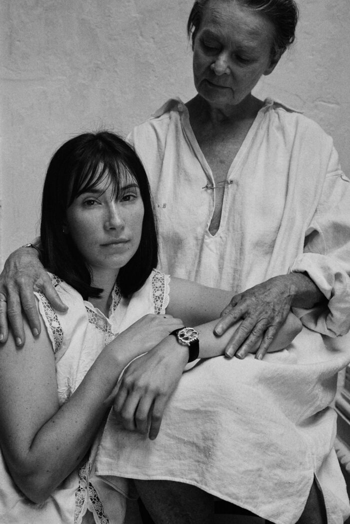 Younger woman and older woman embrace, collaboration with The All Watch.