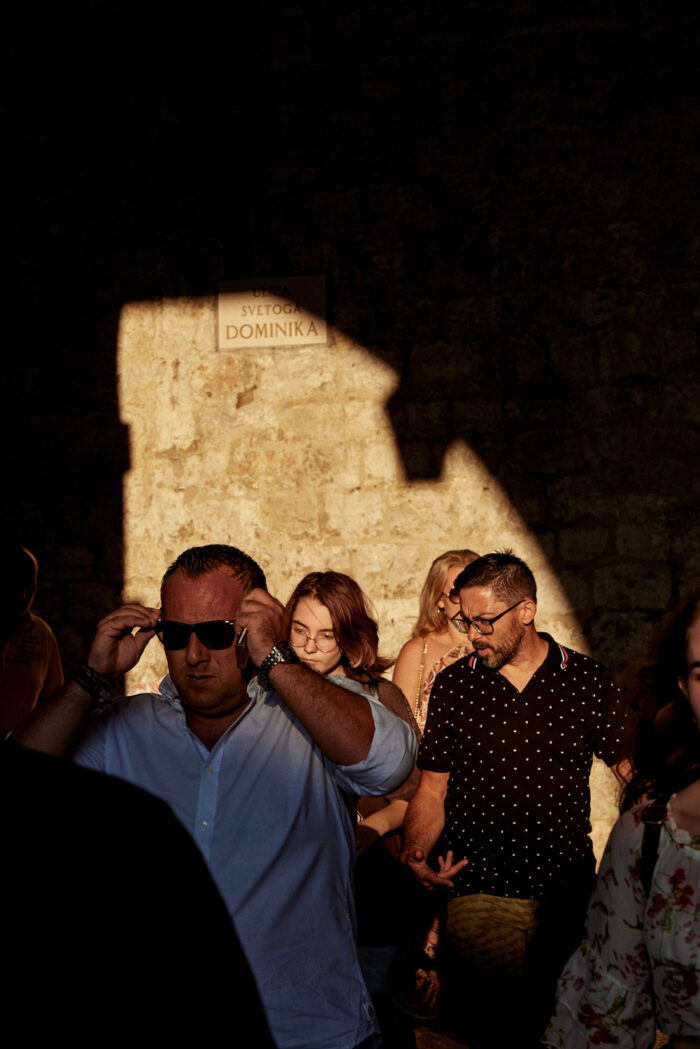 Travel photography by Jules Slutsky, tourists walking through old city of Dubrovnic in Croatia.