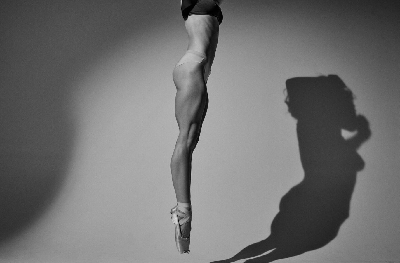 Detail of ballerina's legs jumping mid air